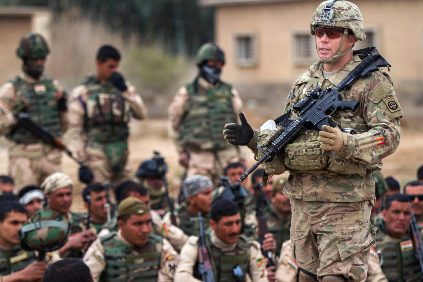 Approximately 250 Iraqi soldiers with 73rd Brigade, 15th Division look on as a cavalry scout with 5th Squadron, 73rd Cavalry Regiment, 3rd Brigade Combat Team, 82nd Airborne Division explains squad-level movement techniques at Camp Taji, Iraq, Tuesday, March 24, 2015. The 3rd Bde., 82nd Abn. Div., was deployed to Iraq as part of Combined Joint Task Force-Operation Inherent Resolve to advise and assist Iraqi Security Forces in their fight against the Islamic State of Iraq and the Levant.   (U.S. Army photo by Sgt. Cody Quinn, CJTF - OIR Public Affairs)