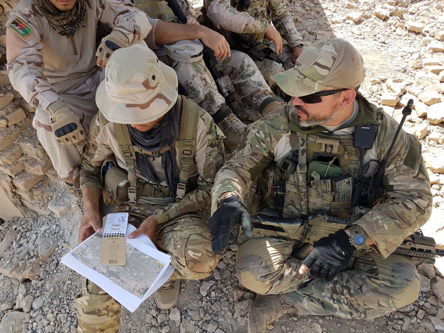 KANDAHAR, AFGHANISTAN (July 10, 2018) -- A coalition Joint Terminal Attack Controller (JTAC) advisor trains two Afghan Territorial Force 444 members from General Command of Police Special Unit (GCPSU) to identify targets on the battlefield during an air-to-ground integration exercise at Tarnak range, Kandahar province, Afghanistan, Jul. 9-10, 2018.  During the two-day exercise, more than 50 Afghan Tactical Air Controllers from both ATF 444 and the Special Mission Wing, advised by U.S. and Coalition partners, directed airstrikes onto simulated static targets. (NATO photo/RELEASED)