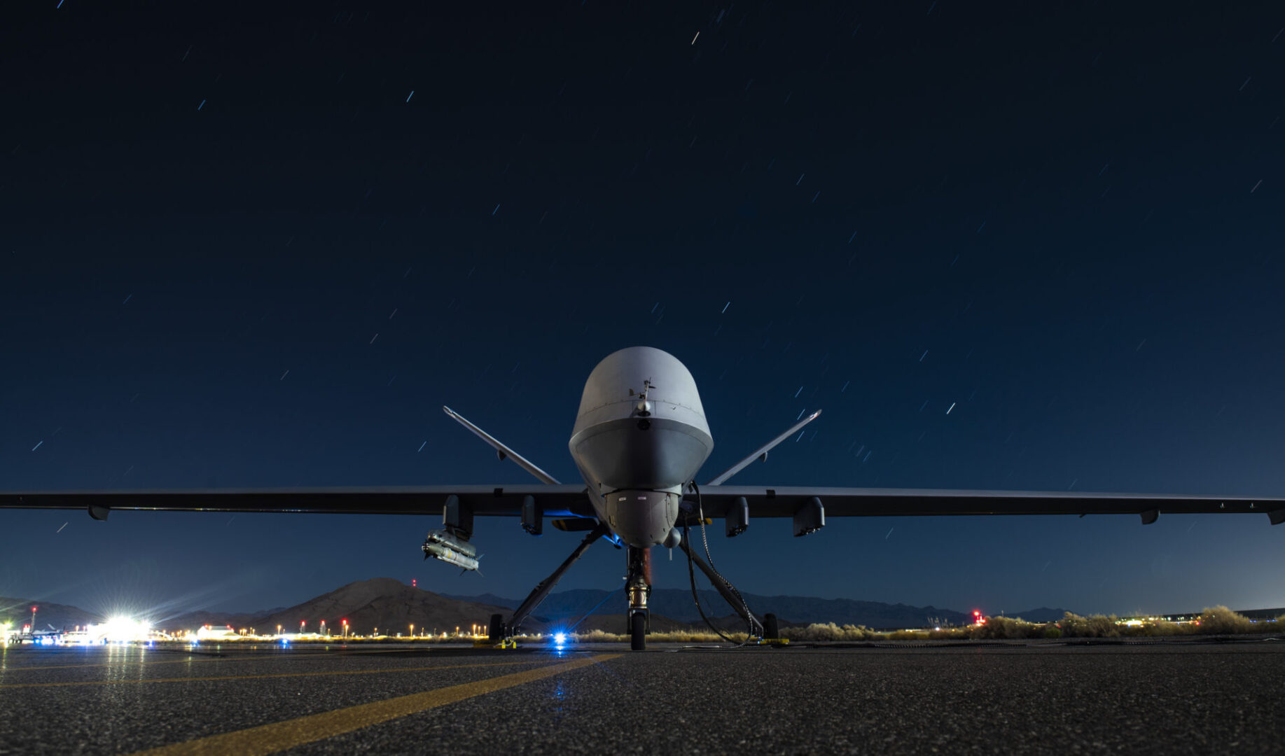 A U.S. Air Force MQ-9 Reaper assigned to the 556th Test and Evaluation Squadron armed with an AIM-9X Block 2 missile sits on the ramp at Creech Air Force Base, Nevada, Sept. 3, 2020. During the weapon test, aircrew successfully employed a live air-to-air AIM-9X Block 2 missile against a target BQM-167 drone simulating a cruise missile. (U.S. Air Force photo by Senior Airman Haley Stevens)